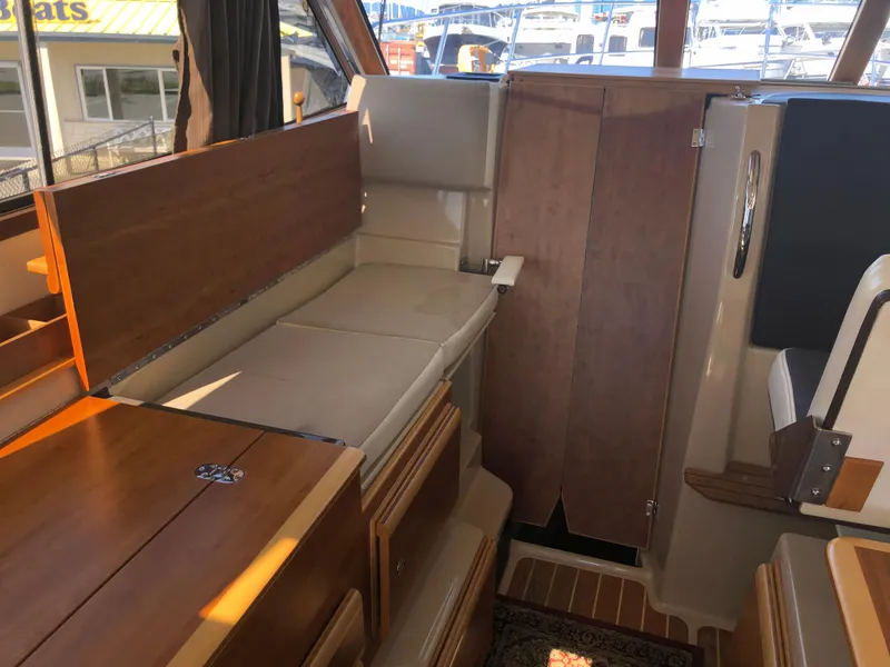 Slide: The Image of Interior of 2016 Cutwater 30 Command Bridge, featuring wood finishes and seating area. - 37