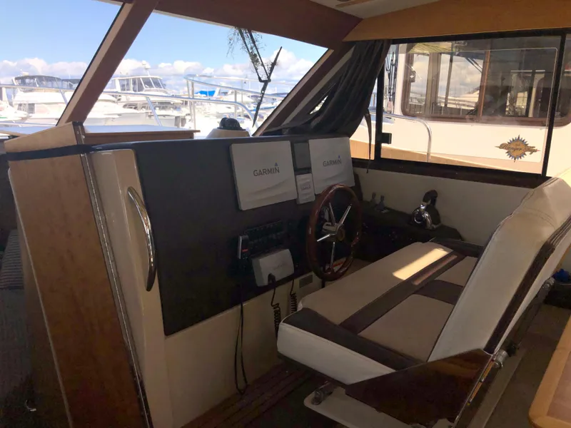 Slide: The Image of Interior of 2016 Cutwater 30 Command Bridge with Garmin navigation system and captain's chair. - 38