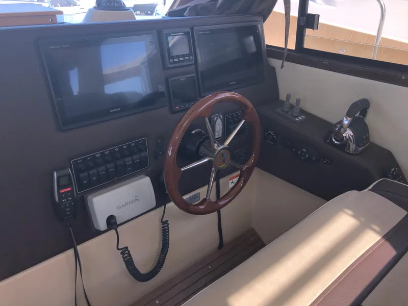 Slide: The Image of 2016 Cutwater 30 Command Bridge helm with steering wheel and navigation equipment. - 39