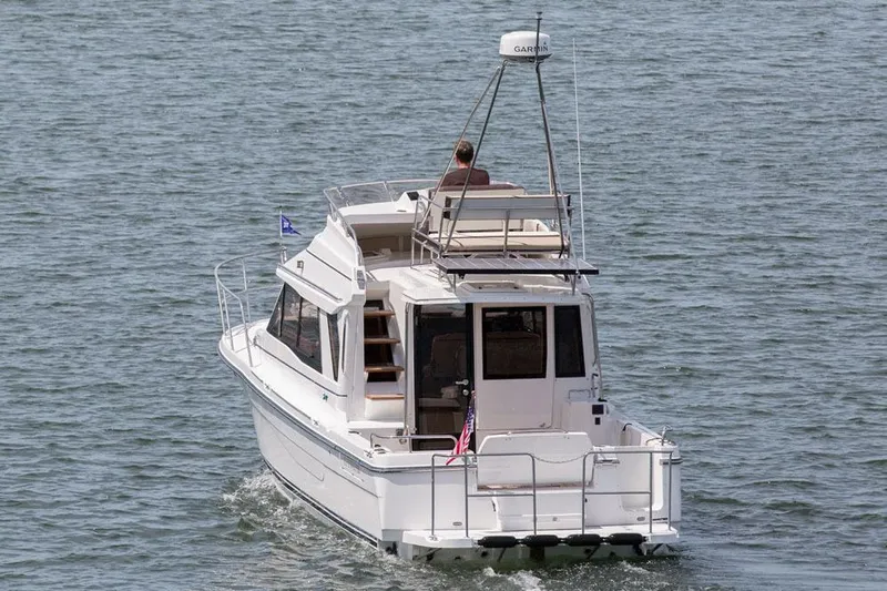 Slide: The Image of 2016 Cutwater 30 Command Bridge cruising on open water, rear view. - 4