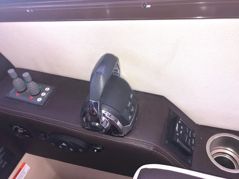 Slide: The Image of Control panel of a 2016 Cutwater 30 Command Bridge boat, featuring throttle and joystick controls. - 40