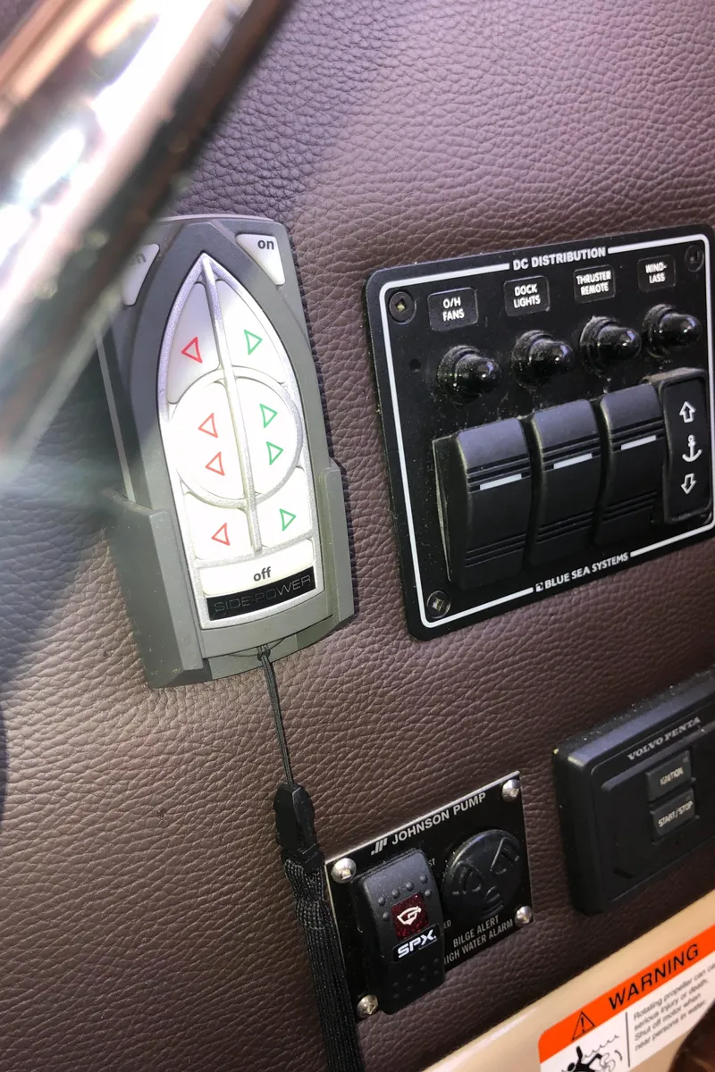 Slide: The Image of Control panel of a 2016 Cutwater 30 Command Bridge boat with switches and buttons. - 41