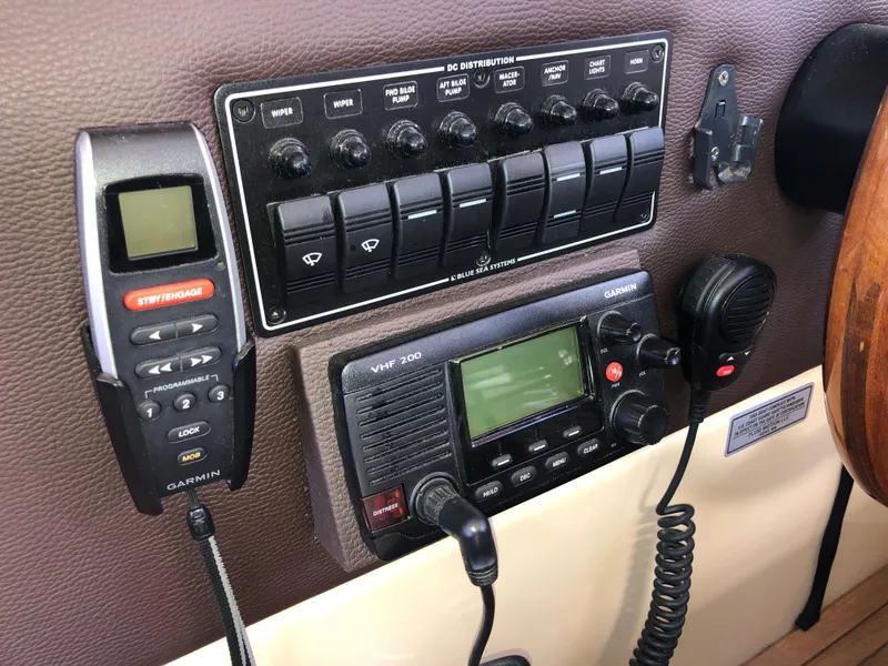 Slide: The Image of Control panel of a 2016 Cutwater 30 Command Bridge with Garmin devices and VHF radio. - 42