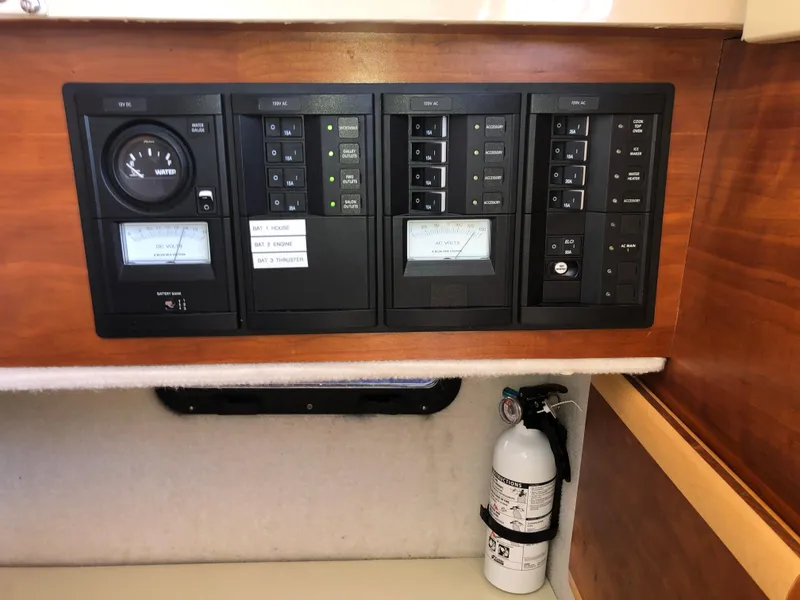 Slide: The Image of Control panel of a 2016 Cutwater 30 Command Bridge boat with fire extinguisher. - 43