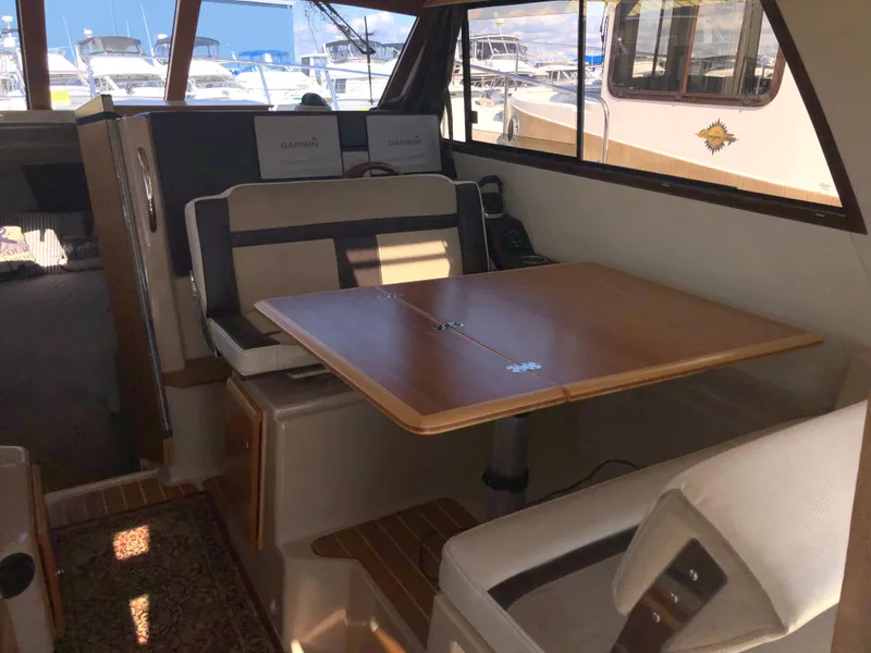 Slide: The Image of 2016 Cutwater 30 Command Bridge interior with dining area and seating. - 46