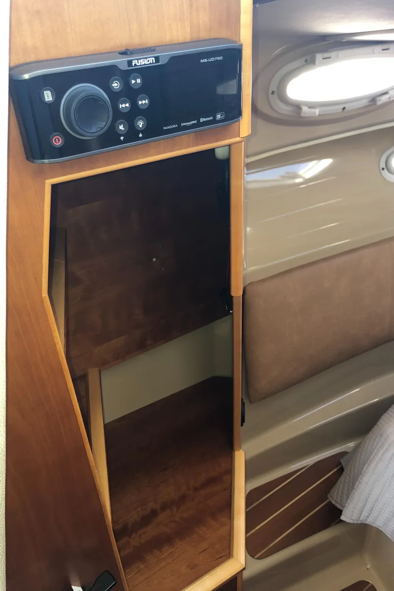 Slide: The Image of Interior of 2016 Cutwater 30 Command Bridge with Fusion audio system and wooden cabinetry. - 47