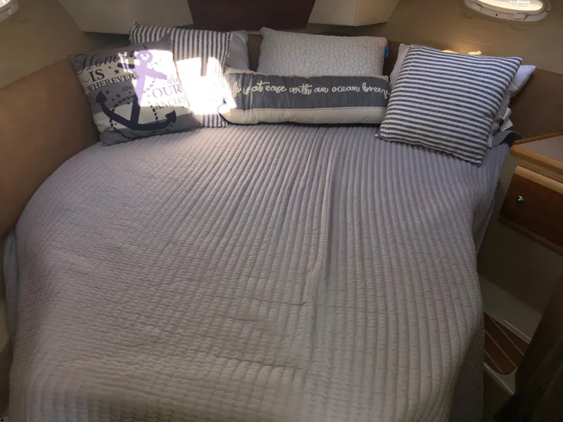 Slide: The Image of Cozy cabin bed in 2016 Cutwater 30 Command Bridge with nautical-themed pillows. - 48