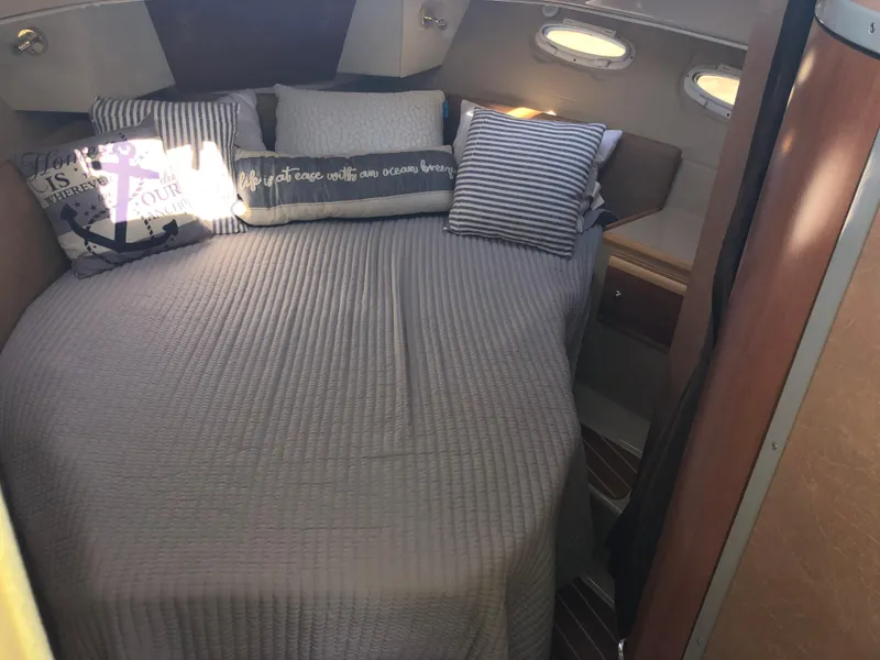 Slide: The Image of Cozy cabin interior of 2016 Cutwater 30 Command Bridge with comfortable bedding and pillows. - 49
