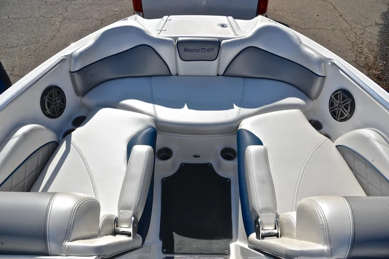 Slide: The Image of 2013 MasterCraft X-35 boat interior with white seating and cup holders. - 22