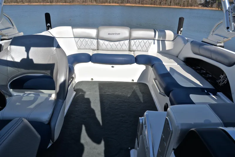 Slide: The Image of 2013 MasterCraft X-35 boat interior with luxurious seating and lake view. - 23