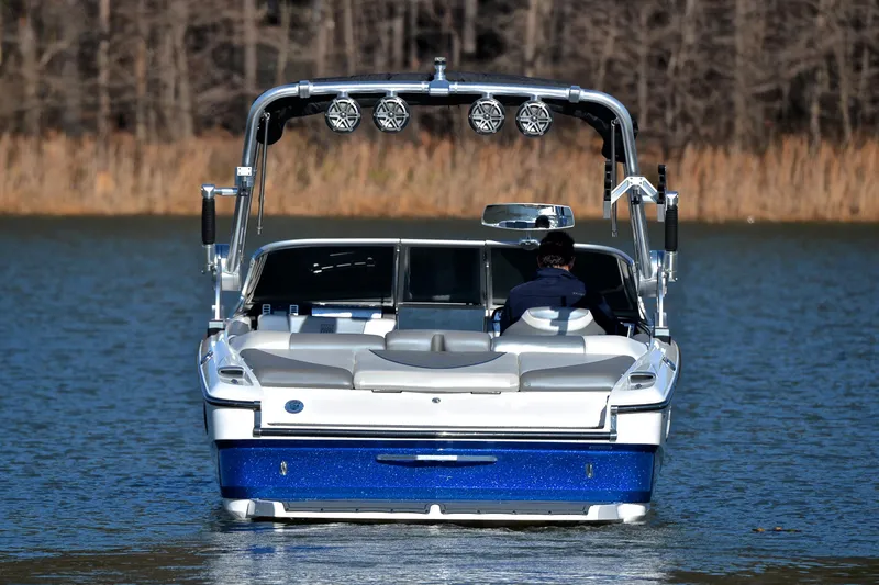 Slide: The Image of 2013 MasterCraft X-35 boat on a lake, rear view with wakeboard tower. - 9