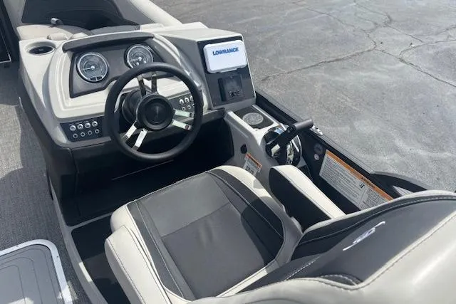 Slide: The Image of 2026 Barletta C22UC boat cockpit with steering wheel, gauges, and Lowrance display. - 6