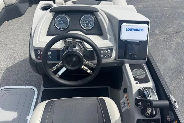 Slide: The Image of 2026 Barletta C22UC boat dashboard with steering wheel and Lowrance display. - 7
