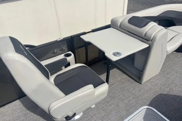 Slide: The Image of 2026 Barletta C22UC boat interior with gray seating and a foldable table. - 8