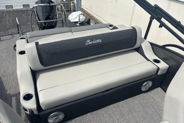 Slide: The Image of 2026 Barletta C22UC boat interior with gray seating and cup holders. - 9