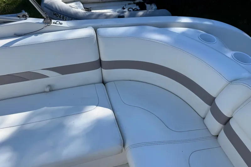 Slide: The Image of White leather seating on a 2001 Formula 260 Sun Sport boat, featuring cup holders. - 15