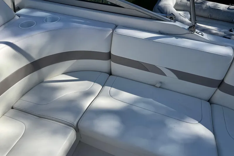 Slide: The Image of 2001 Formula 260 Sun Sport boat interior with white cushioned seating and cup holders. - 16