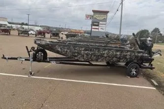 The Image of 2026 Excel 1751 Shallow Water F4 boat with camouflage design on a trailer. - 0