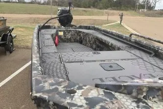 Slide: The Image of 2026 Excel 1751 Shallow Water F4 boat with camouflage design in a parking area. - 5