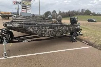 Slide: The Image of 2026 Excel 1751 Shallow Water F4 boat with camouflage design on a trailer. - 6