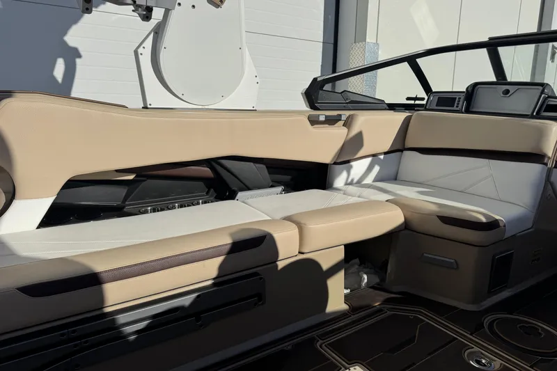 Slide: The Image of 2023 Supra SL 575 boat interior with beige and white seating, modern design. - 10