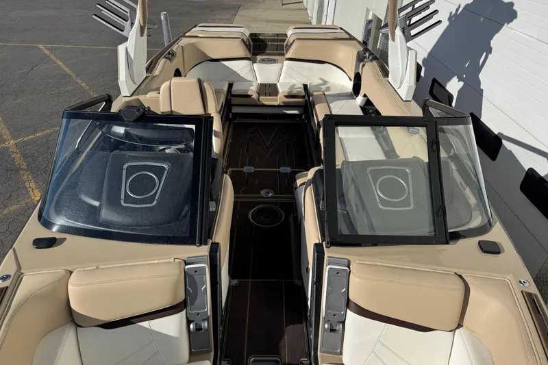 Slide: The Image of 2023 Supra SL 575 boat interior with beige seating and sleek design. - 6