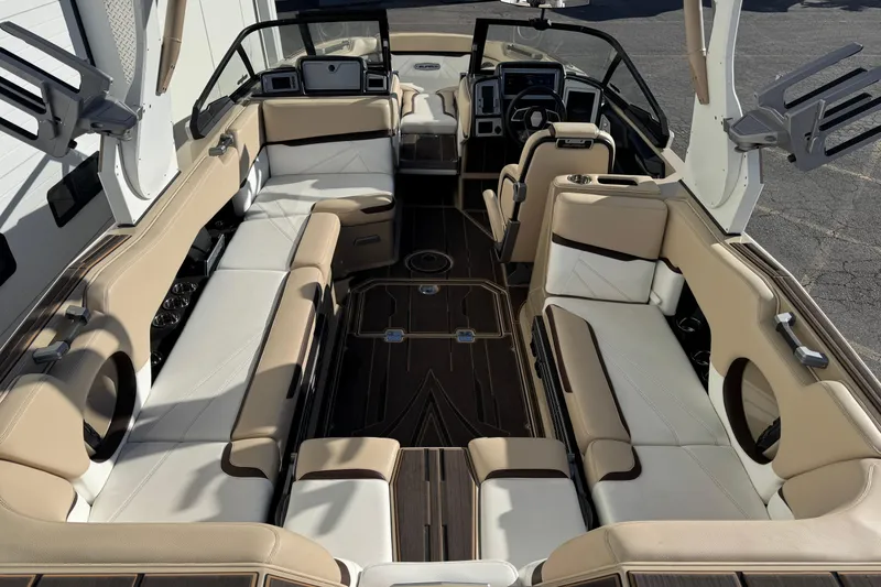 Slide: The Image of Luxurious interior of 2023 Supra SL 575 boat with beige seating and modern dashboard. - 9
