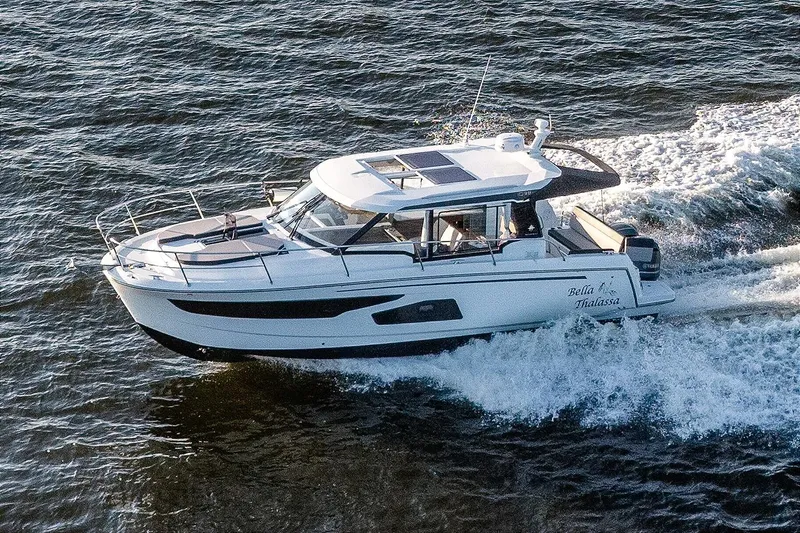 The Image of 2021 Jeanneau NC 1095 motor yacht cruising on open water. - 1
