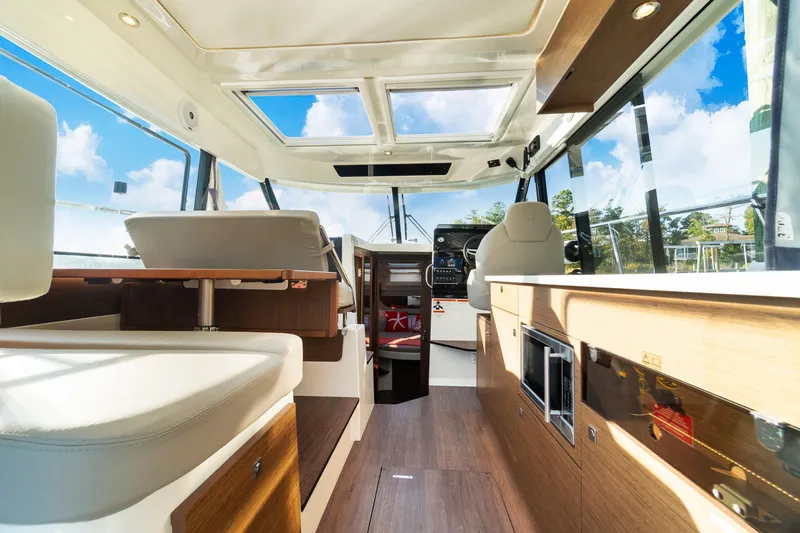 Slide: The Image of Interior of 2021 Jeanneau NC 1095 boat with modern design and panoramic windows. - 45