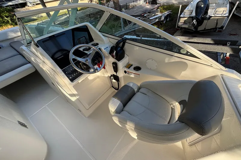 Slide: The Image of 2021 World Cat 230 SD boat cockpit with steering wheel and comfortable seating. - 13