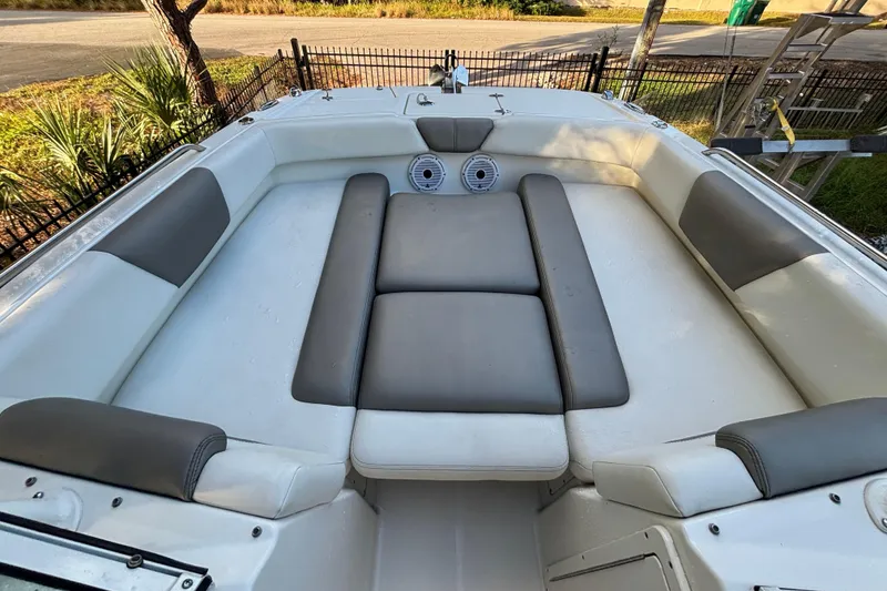 Slide: The Image of 2021 World Cat 230 SD boat interior with cushioned seating and speakers. - 14