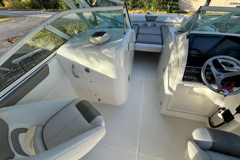 Slide: The Image of Interior view of 2021 World Cat 230 SD boat, featuring seating and steering console. - 8