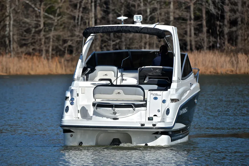 Slide: The Image of 2018 Monterey 275 Sport Yacht cruising on a calm lake, rear view. - 10