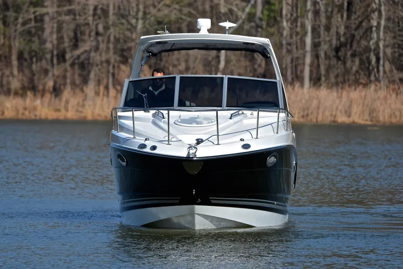 Slide: The Image of 2018 Monterey 275 Sport Yacht cruising on a calm lake with forest backdrop. - 12