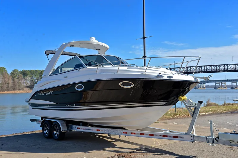 Slide: The Image of 2018 Monterey 275 Sport Yacht on trailer by a scenic waterfront. - 19