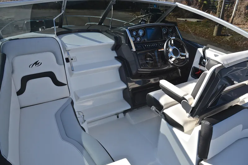 Slide: The Image of 2018 Monterey 275 Sport Yacht interior with sleek dashboard and comfortable seating. - 24