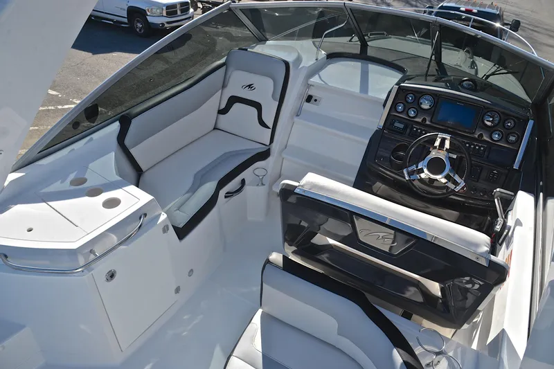 Slide: The Image of 2018 Monterey 275 Sport Yacht interior with sleek dashboard and comfortable seating. - 25