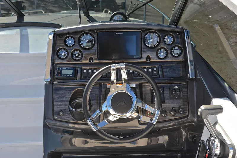 Slide: The Image of Cockpit of 2018 Monterey 275 Sport Yacht with modern controls and steering wheel. - 29