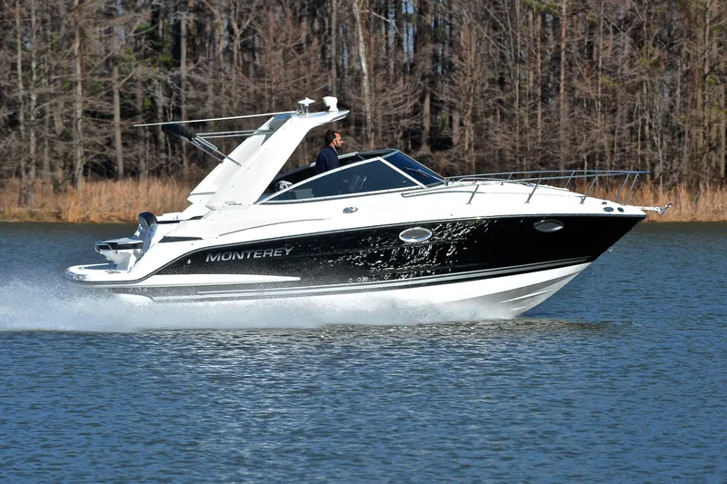 Slide: The Image of 2018 Monterey 275 Sport Yacht cruising on a lake with forested background. - 3