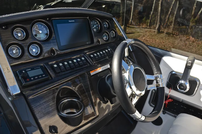 Slide: The Image of Dashboard of a 2018 Monterey 275 Sport Yacht with steering wheel and control panel. - 30