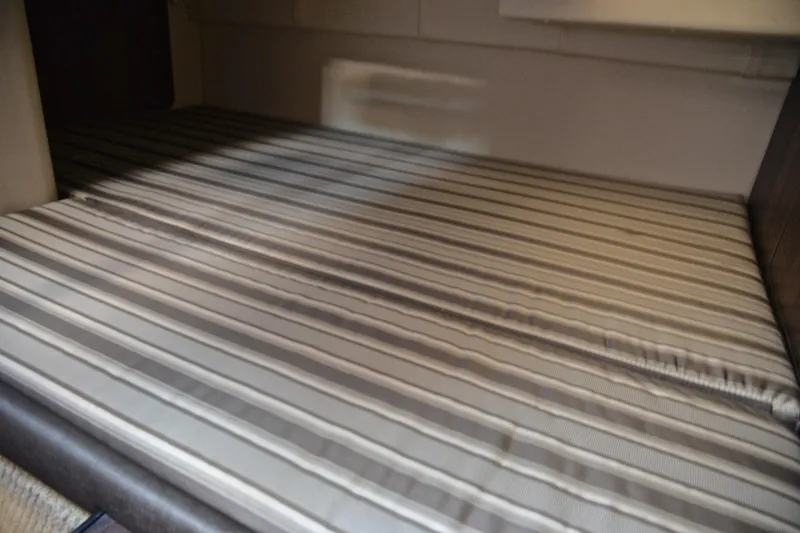 Slide: The Image of Interior cabin bed of 2018 Monterey 275 Sport Yacht with striped mattress. - 36