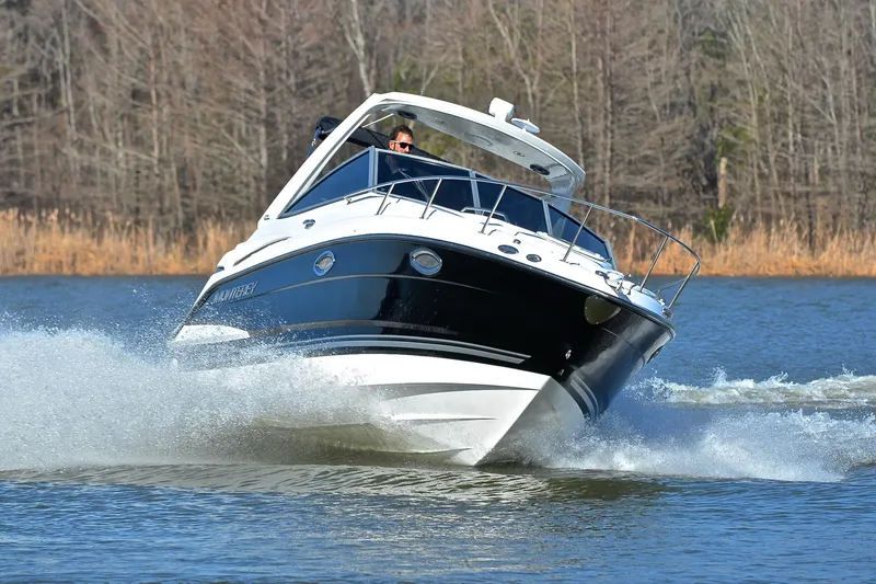 Slide: The Image of 2018 Monterey 275 Sport Yacht cruising on a lake with trees in the background. - 7