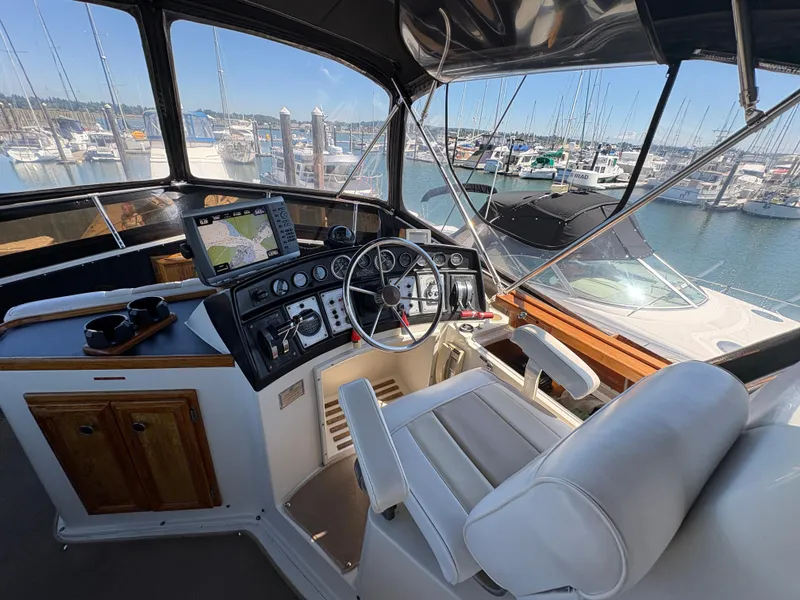 Slide: The Image of Helm of 1988 Carver 36 Aft Cabin yacht with marina view. - 12