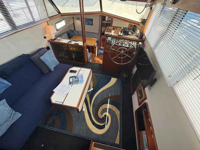 Slide: The Image of Interior of 1988 Carver 36 Aft Cabin with cozy seating and nautical decor. - 20