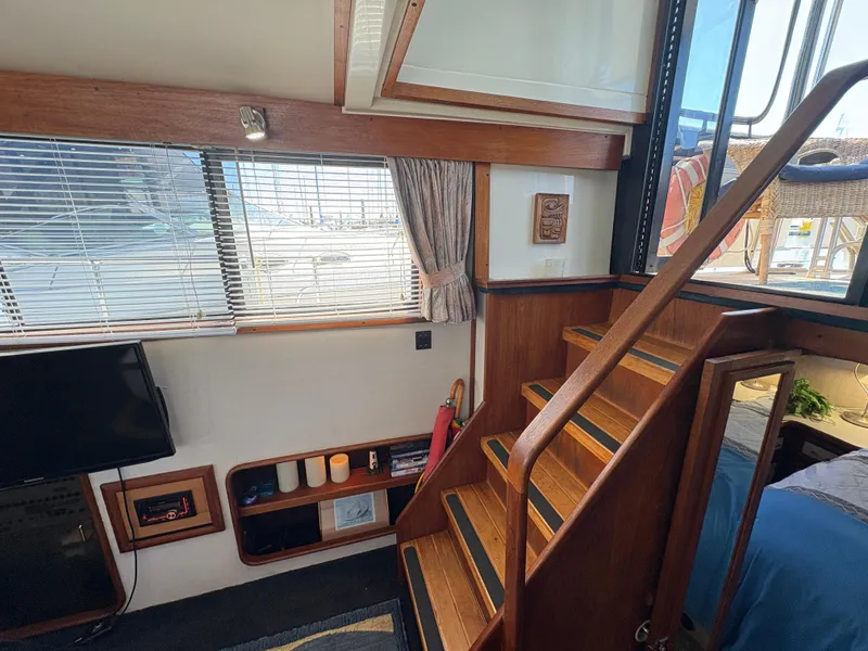 Slide: The Image of Interior of 1988 Carver 36 Aft Cabin with wooden stairs and cozy decor. - 22