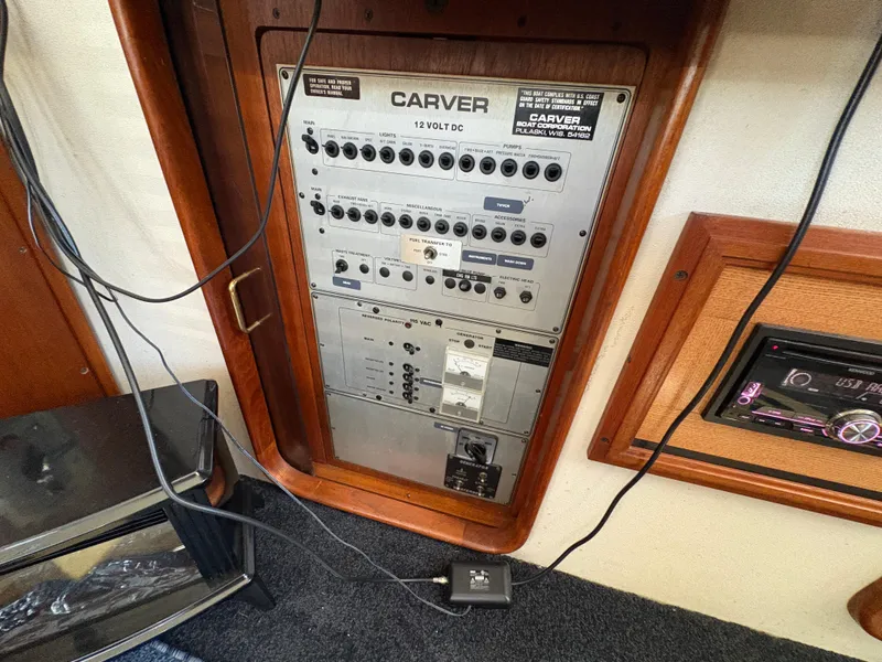 Slide: The Image of Electrical panel of a 1988 Carver 36 Aft Cabin boat, featuring various switches and controls. - 23