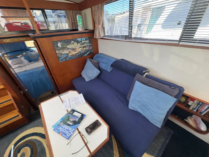 Slide: The Image of Interior of 1988 Carver 36 Aft Cabin with blue sofa and nautical decor. - 25