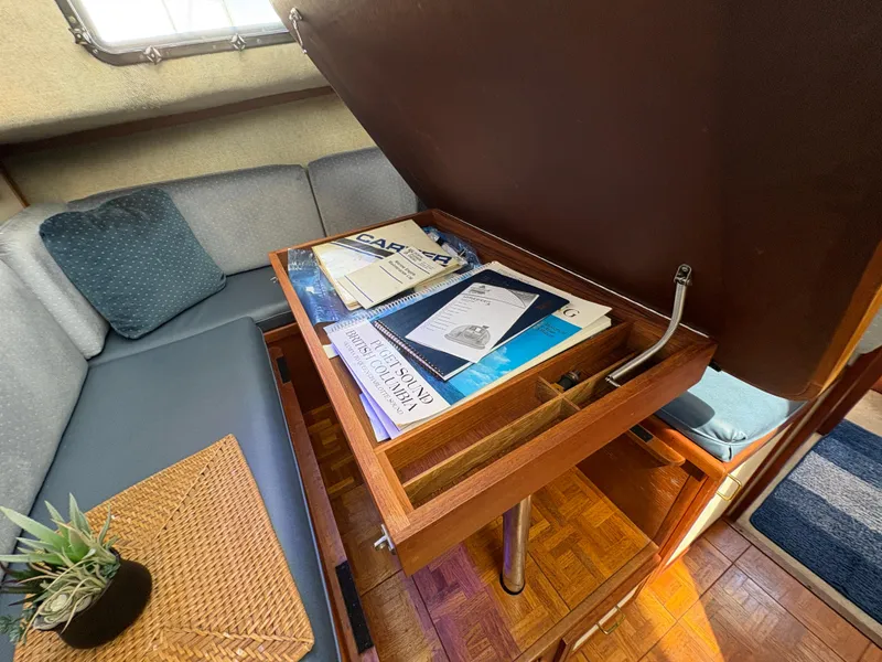 Slide: The Image of 1988 Carver 36 Aft Cabin interior with open storage, books, and cozy seating. - 29