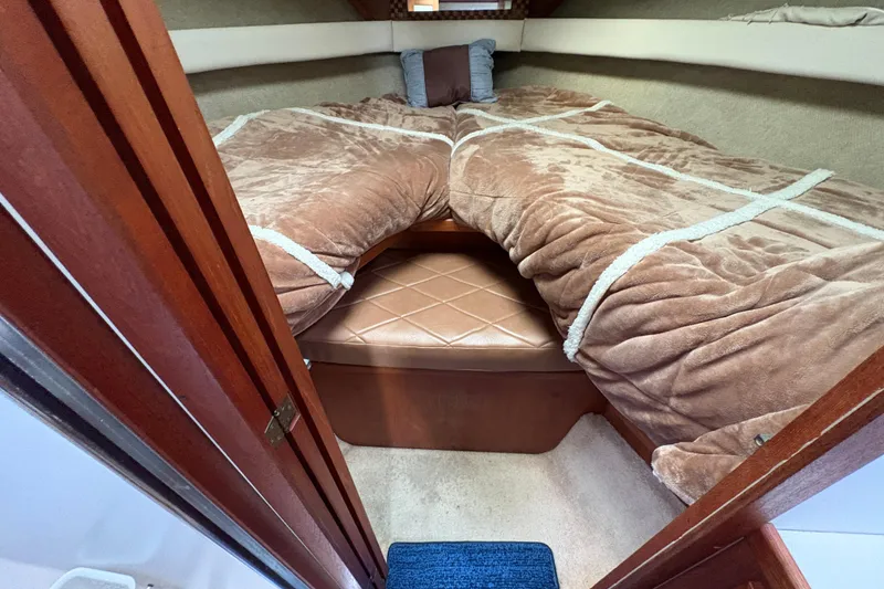 Slide: The Image of Cozy cabin interior of 1988 Carver 36 Aft Cabin with plush bedding and wood accents. - 31