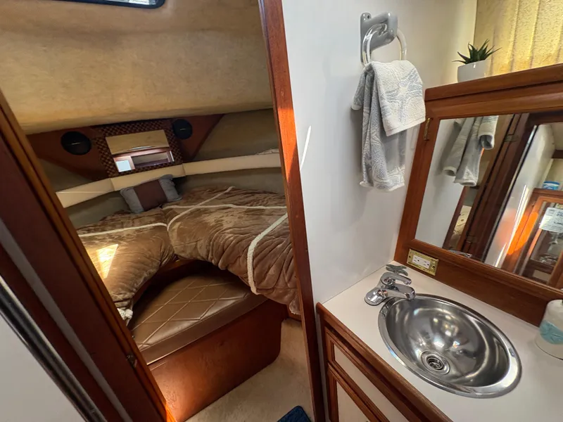 Slide: The Image of 1988 Carver 36 Aft Cabin interior with cozy bedroom and compact bathroom sink area. - 33